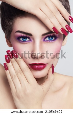 Close-up portrait of young beautiful woman with stylish make-up and long nails