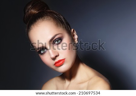 Young beautiful woman with stylish make-up with hair bun