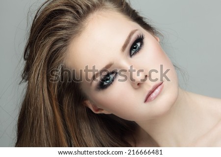 Close-up portrait of young beautiful teen girl with smoky eyes make-up