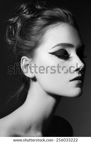 Black and white portrait of young beautiful girl with stylish cat eye makeup