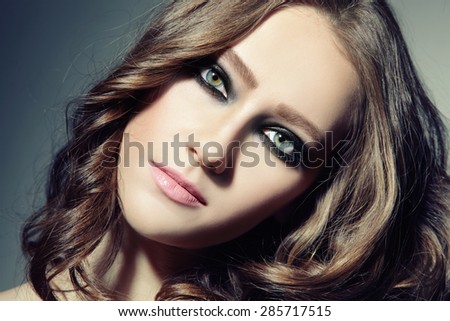 Close-up portrait of young beautiful woman with stylish smokey eyes