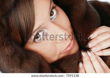 Close-up portrait of beautiful big-eyed girl an brown fur jacket