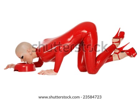 Girl in red latex catsuit and stilettos licking milk like cat, over white background