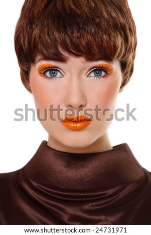 Portrait of beautiful redhead woman with stylish orange makeup over white background