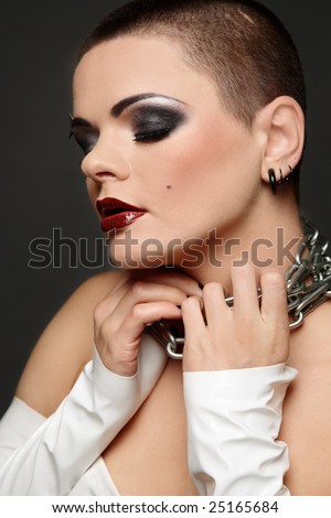 Girl in white vinyl dress and gloves holding chain on her neck, selective focus