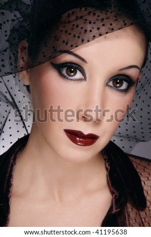 Portrait of beautiful woman with stylish makeup and black veil on head