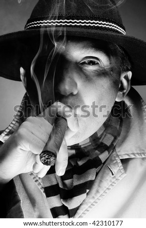 Black and white old-fashioned portrait of man smoking cigar