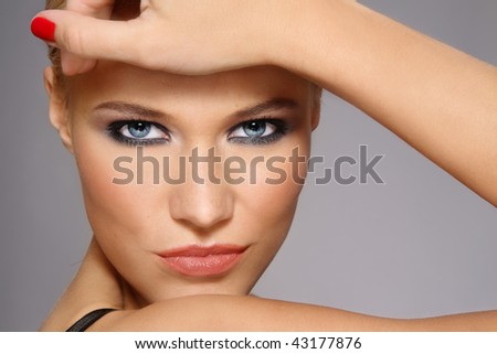 Close-up portrait of beautiful stylish blonde girl with trendy make-up
