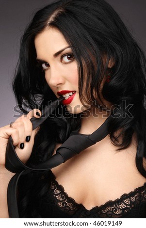 Young beautiful sexy woman in black bra and necktie