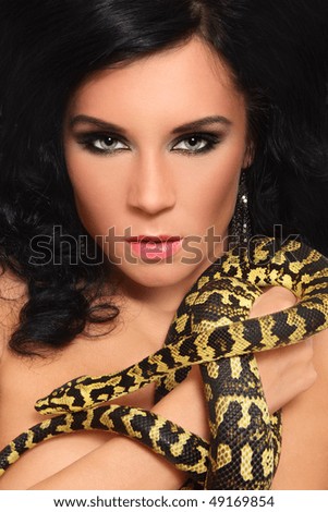 Portrait of beautiful tanned brunette with snake
