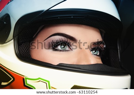 Close-up portrait of beautiful woman with stylish makeup in biker helmet