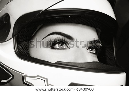 Close-up duotone portrait of beautiful woman in biker helmet