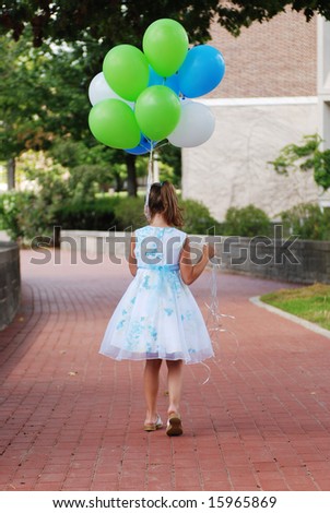 A cute girl walking with her balloons