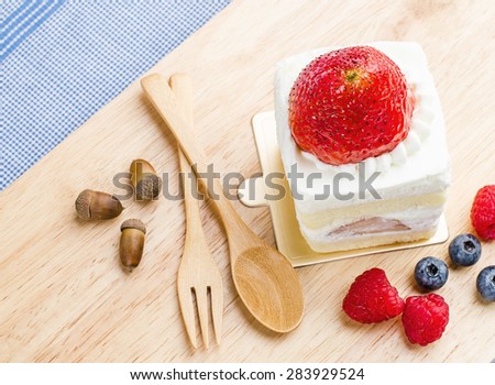 Strawberry cake on wooden background, Cake with strawberries, Piece of cake, raspberries and blueberrys.