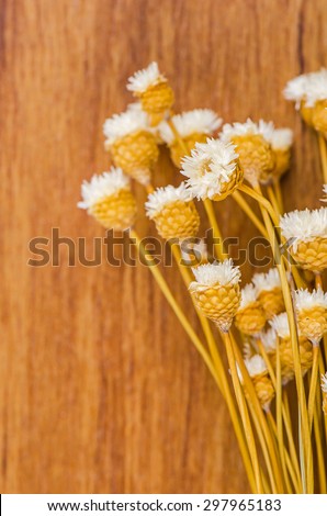 Bouquet of dried flowers on wooden background.