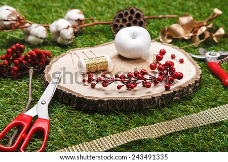 composition consisting of decorative elements and tools florist on the green background closeup