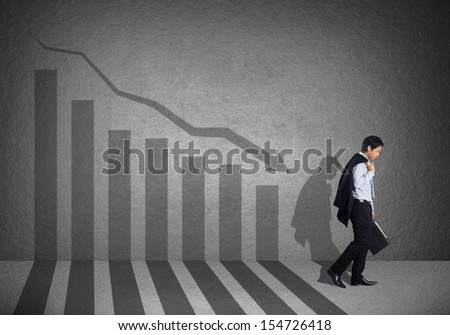 Young business man with failure chart