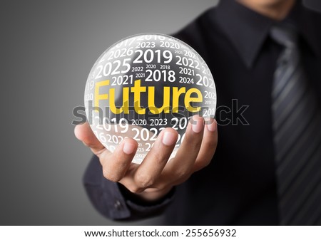 Businessman holding a glass ball,foretelling the future.