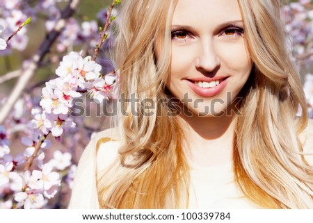 Beautiful young woman in peach garden