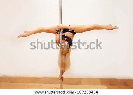 Girl making figure of pole dance sport