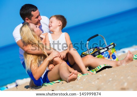 Family of three person on the beach