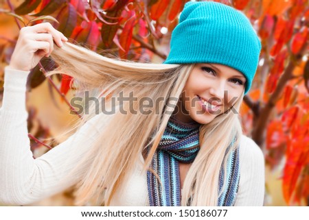 Beautiful woman in peach autumn garden
