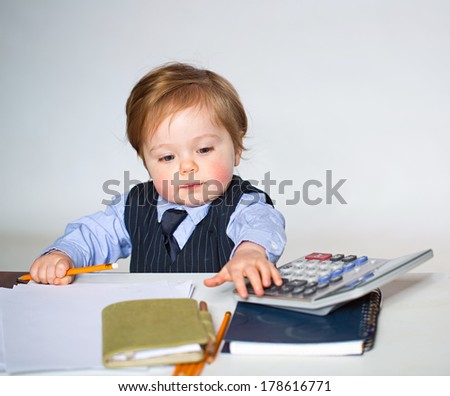 Little businessman portrait in office