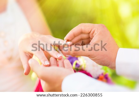 Man wears a ring on the finger of woman
