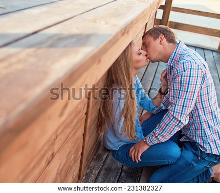 Two young lovers kissing on the street