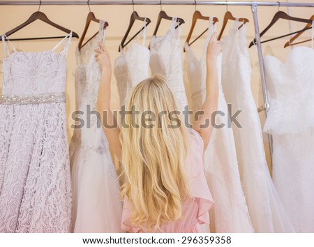 woman is choosing a wedding dress in the shop