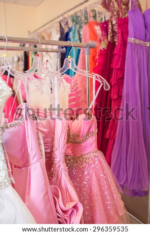 A few beautiful wedding or evening dresses on a hanger