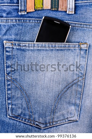 Mobile phone in your pocket jeans. Close-up Photos