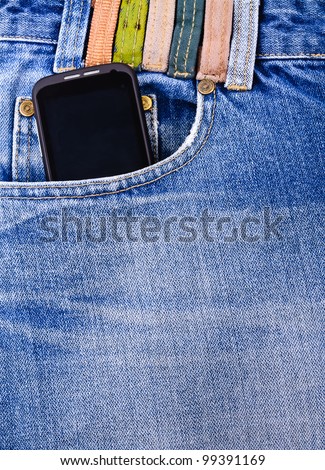 Mobile phone in your pocket jeans. Close-up Photos