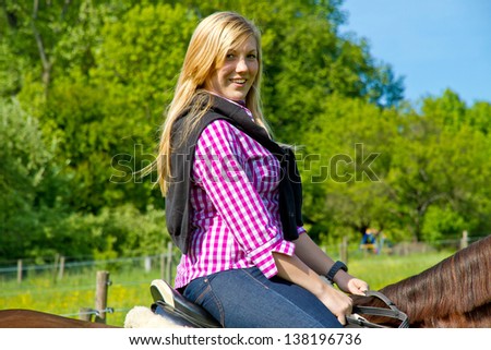 Young woman, horseback riding