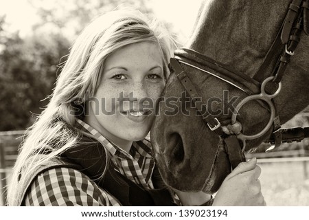 Photo of a young woman who loves her horse - black and white