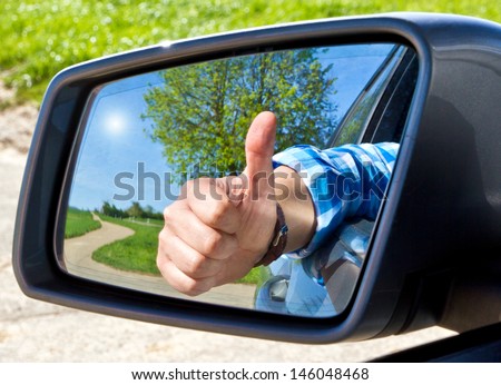 Car driver with thumb up