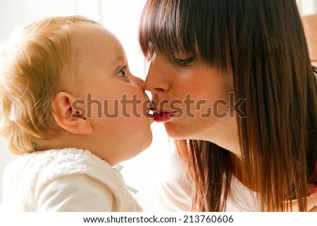 Mother kiss her baby