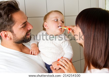 Happy family and health. mother brushing teeth of their baby
