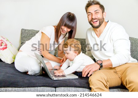 Young, happy family with computer
