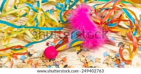 Colorful party decoration with hat, streamer and confetti