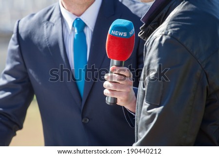 news journalist with microphone interviewing