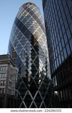LONDON - JANUARY 31 - 2011: The famous London Gherkin tower- january 31, 2011 in London. the tower is 180 metres tall, and stands on the former site of the Baltic Exchange building