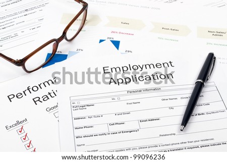 Pen, Glasses and Employment Application Form on desktop in business office.