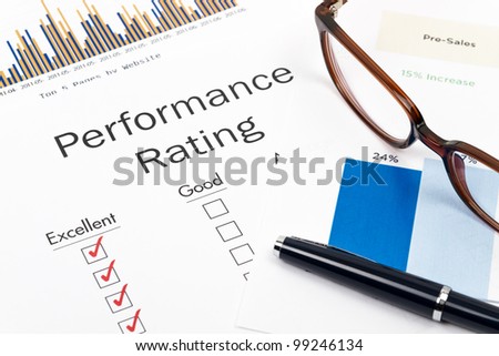 Pen, Glasses and Performance Rating Form on desktop in business office.