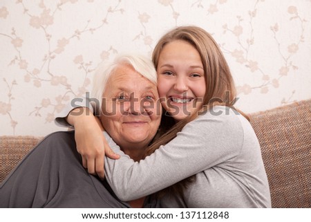 Young woman hugging her grandmother