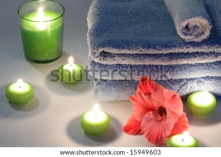 Candles, a towel and flowers for spa