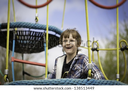 A Young Girl On Rope Climbing Frame
