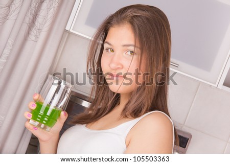 Young girl with long hair, eat breakfast in the kitchen