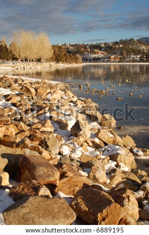 Frozen lake with rocks on the ice; Big Bear Lake, California.