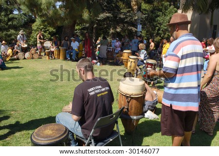 SAN DIEGO, CA - APRIL 19: Musicians playing various percussion instruments in a drum circle at Earth Fair on April 19, 2009 in San Diego. The fair is a large annual event held at Balboa Park in San Diego.